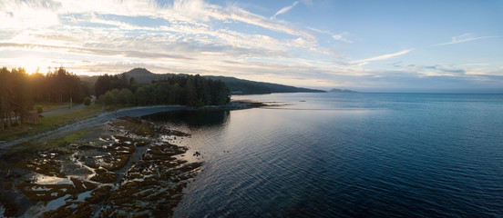 Aerial panoramic view of a small town, Port Hardy, during a cloudy summer sunset. Located in Northern Vancouver Island, BC, Canada.