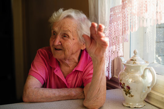 Elderly woman in her home, portrait at kitchen.