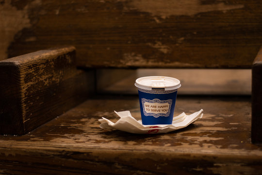Paper Coffee Cup In New York City On A Napkin On A Bench  In Subway Station