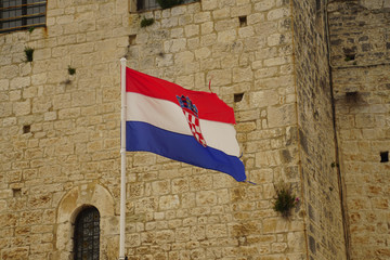 Croatian flag displayed against limestone outer walls