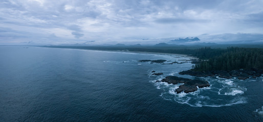 Naklejka na ściany i meble Aerial panoramic seascape view of the Pacific Ocean Coast during a cloudy summer sunset. Taken near Tofino and Ucluelet, Vancouver Island, BC, Canada.