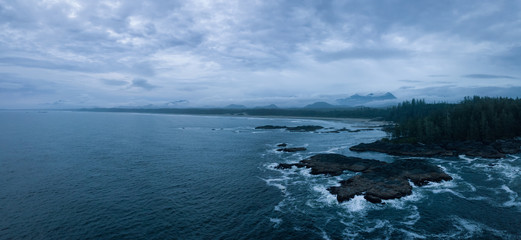 Aerial panoramic seascape view of the Pacific Ocean Coast during a cloudy summer sunset. Taken near Tofino and Ucluelet, Vancouver Island, BC, Canada.