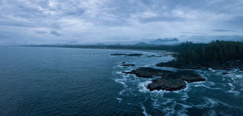 Aerial panoramic seascape view of the Pacific Ocean Coast during a cloudy summer sunset. Taken near Tofino and Ucluelet, Vancouver Island, BC, Canada.