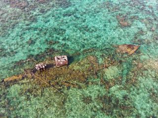 Half Submerged Shipwreck on Coral Reef