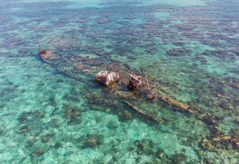 Half Submerged Shipwreck on Coral Reef