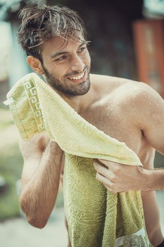 Young Caucasian Man Using A Towel After A Nice Outdoor Beach Shower