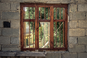 An old broken window on a forgotten building, vintage and aged