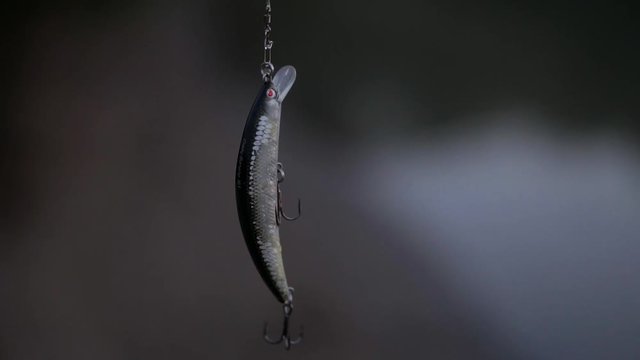 The fisherman throws a fishing pole into the river.