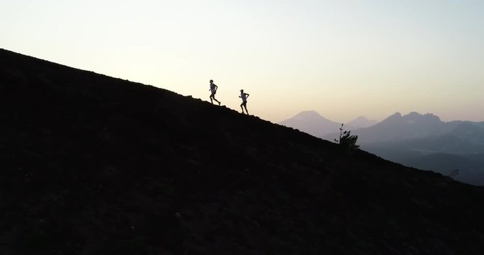 Runners at sunset on a mountain