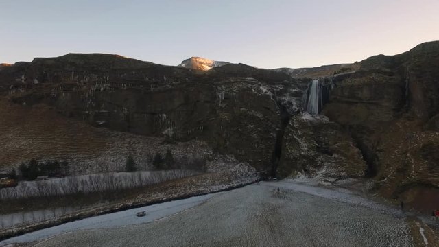 Rising aerial static shot over Icelandic Waterfall Wide aerial shot flying towards and over Icelandic Waterfall Glj&radic;&int;frab&radic;&int;i