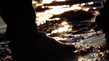 Person finding a Message in a Bottle on the shoreline