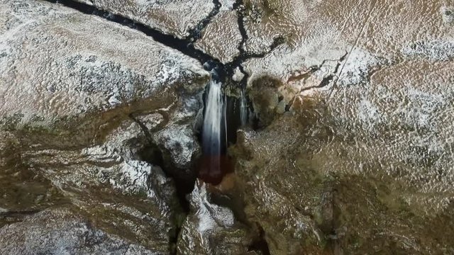 Bird's eye aerial fly by over Icelandic Waterfall Wide aerial shot flying towards and over Icelandic Waterfall Glj&radic;&int;frab&radic;&int;i