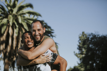 Gay couple hugging in the park