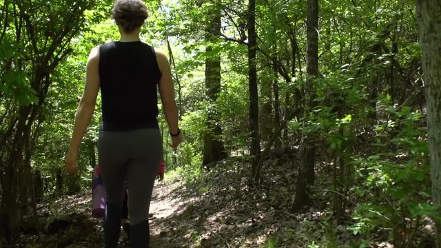 Group of women walking through the forest to yogafest in Fayetteville Arizona