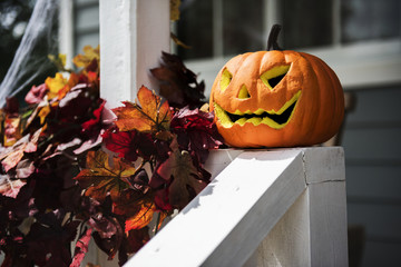 Halloween pumpkins and decorations outside a house