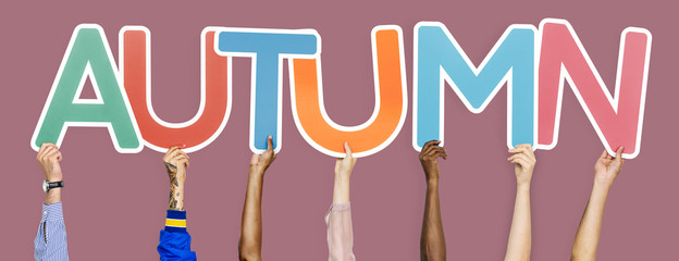 Hands holding the word Autumn