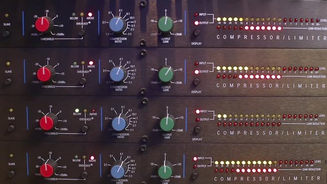 technician adjusting settings on an audio compressor