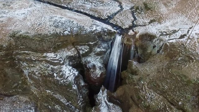 Bird's eye aerial rising shot over Icelandic Waterfall Wide aerial shot flying towards and over Icelandic Waterfall Glj&radic;&int;frab&radic;&int;i