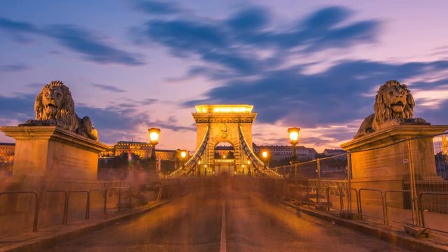 Budapest, Hungary, Szechenyi Chain Bridge with a blurred crowd of people at sunset. Time lapse. Zoom effect