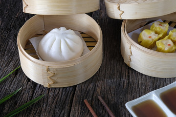Hot buns dim sum on wooden table.