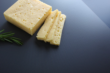 cheese cut on a gray background