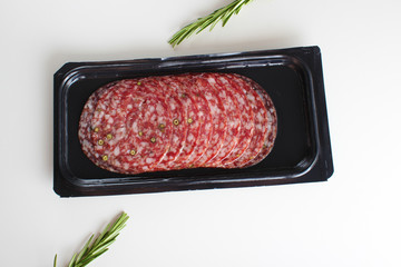 sausage sliced in a package on a white background