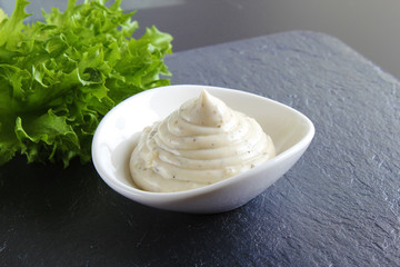 mayonnaise sauce, sour cream on a stone background