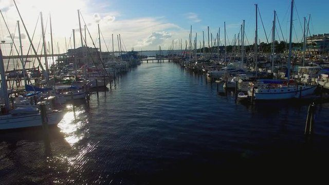 Drone footage of sail boats on the riverside