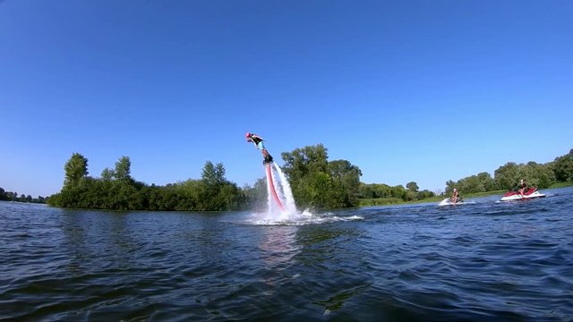 Two Flyboarders diving slow motion into the water flying doing tricks Flyboarding wide shot video