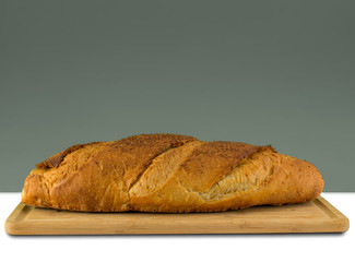 Brown bread on wooden board with copy space