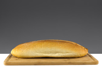 White bread on wooden board, dark gray color background with copy space