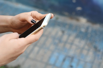 Young women sending message with smartphone.