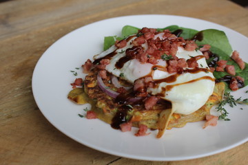 Zucchini and Sweet Potato Fritters with fried egg, bacon and salad, gourmet