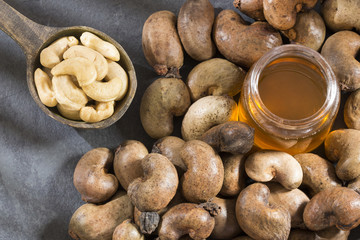 Fototapeta na wymiar Walnuts and cashew oil on the table - Anacardium occidentale