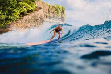 Surf girl on long surfboard. Woman in ocean during surfing. Surfer and ocean wave