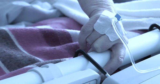 4K, The Patient In The Hospital Has A Central Puncture (catheter). The Woman Lies On The Hospital Bed. She Moves Her Bandaged Hand. Panning Camera, Pan, Closeup,