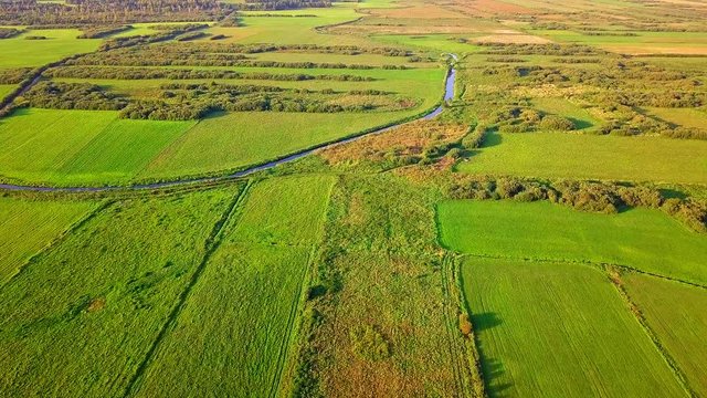 4k AERIAL: Flight over river flowing through fields. Beautiful landscape. 3840x2160, 30fps.
