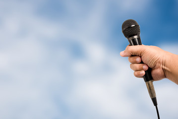 Handheld microphones on background blur. © chalermphon