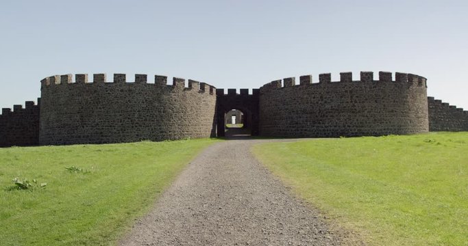 The ruins of an old Irish castle sits on cliffs overlooking the ocean.