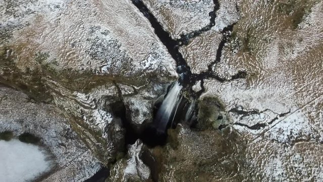 Bird's eye aerial rotation over Icelandic Waterfall Wide aerial shot flying towards and over Icelandic Waterfall Glj&radic;&int;frab&radic;&int;i