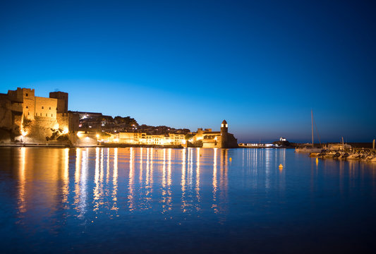 Beautiful small bay with old church of Our Lady of the Angels in the Collioure at late evening.