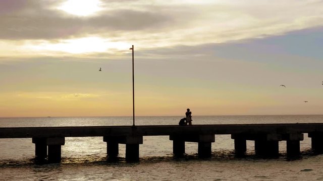 DOCK SUNSET MOTHER AND DAUGHTER