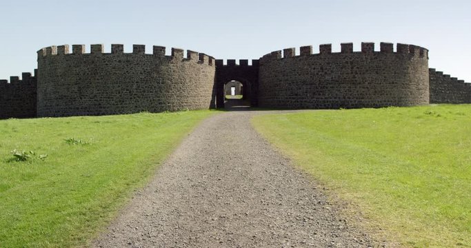 The ruins of an old Irish castle sits on cliffs overlooking the ocean.