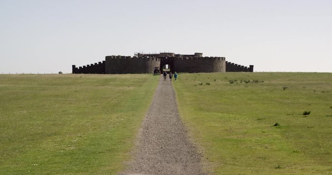 The ruins of an old Irish castle sits on cliffs overlooking the ocean.