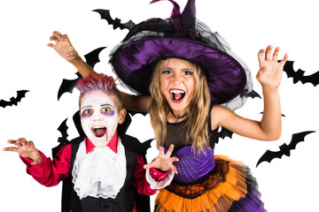 Halloween kids, Happy scary girl and boy dressed up in halloween costumes of witch, sorcerer and vampire, Dracula for pumpkin patch and halloween party