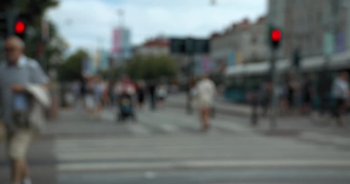 Blurred people and trams at a street cross in central Gothenburg