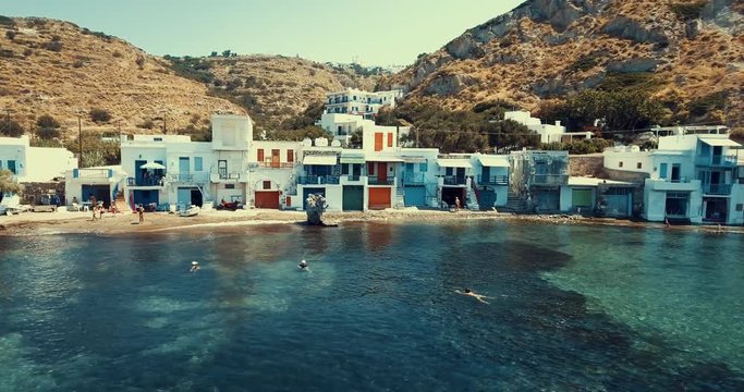 Drone Aerial of Mandrakia village on Mylos in Greece with boats and typical fisherman houses next to the sea side