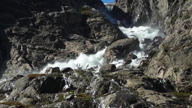 Slow motion video of fresh water river coming down from norwegian Glacier Folgefonna.