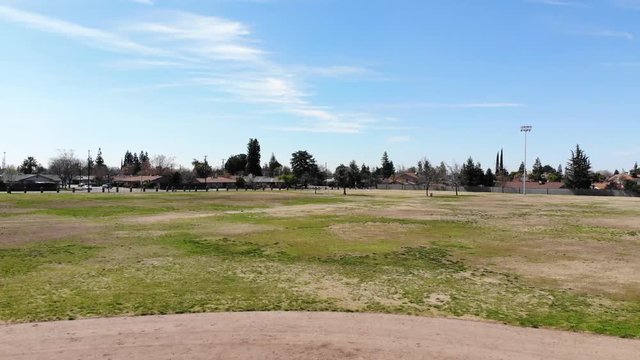 Beautiful aerial drone shot of a suburban Park in Clovis California with a United States Flag.