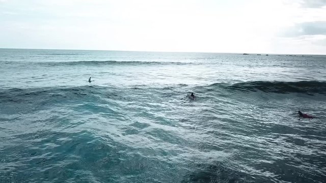 Surfers waiting for waves to ride in Guiones Beach, Nosara, Guanacaste, Costa Rica.